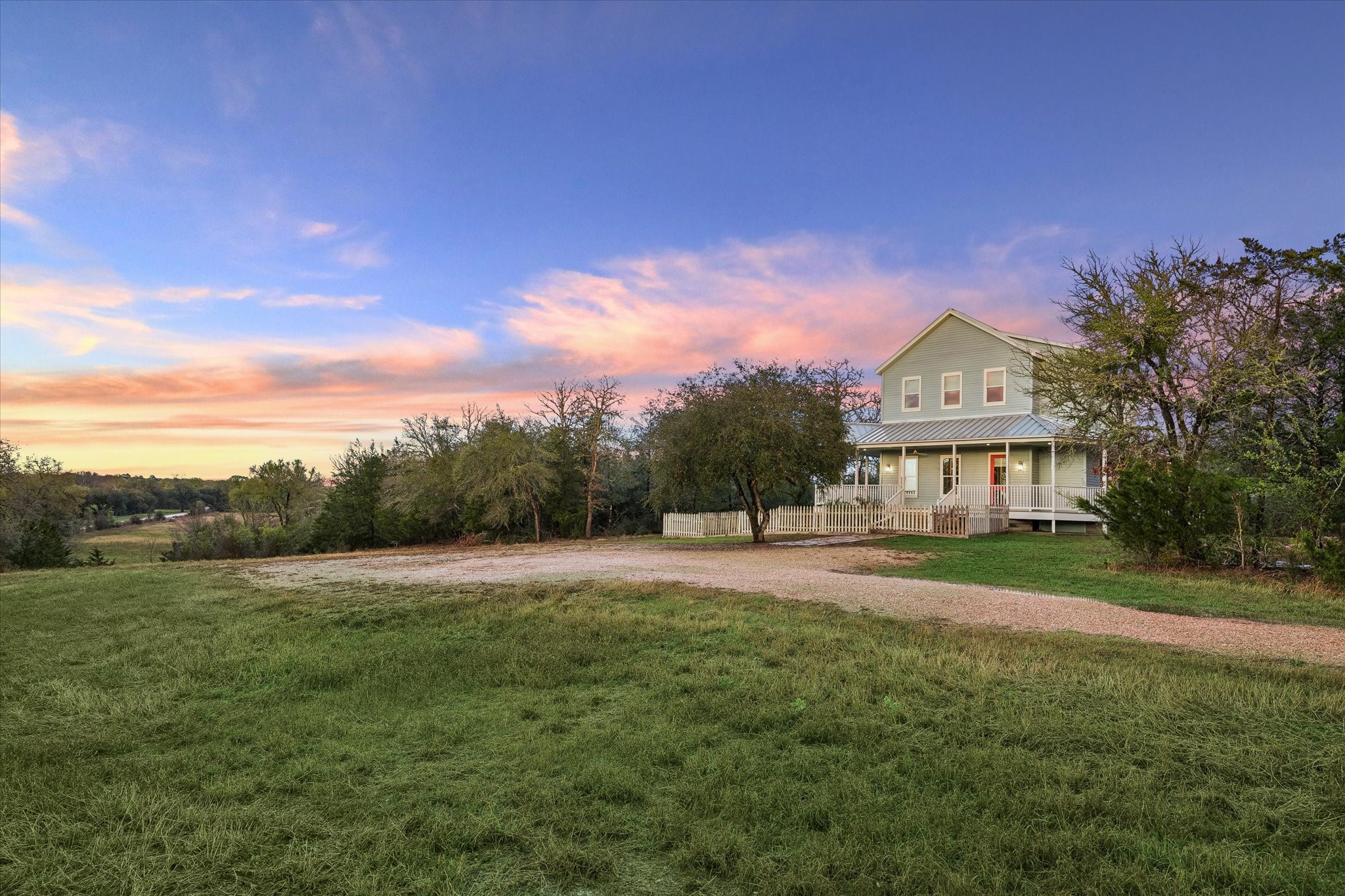 895 South Weyand Road Round Top, TX 78954 - Photo 28 of 37 a front view of a house with a yard and garage
