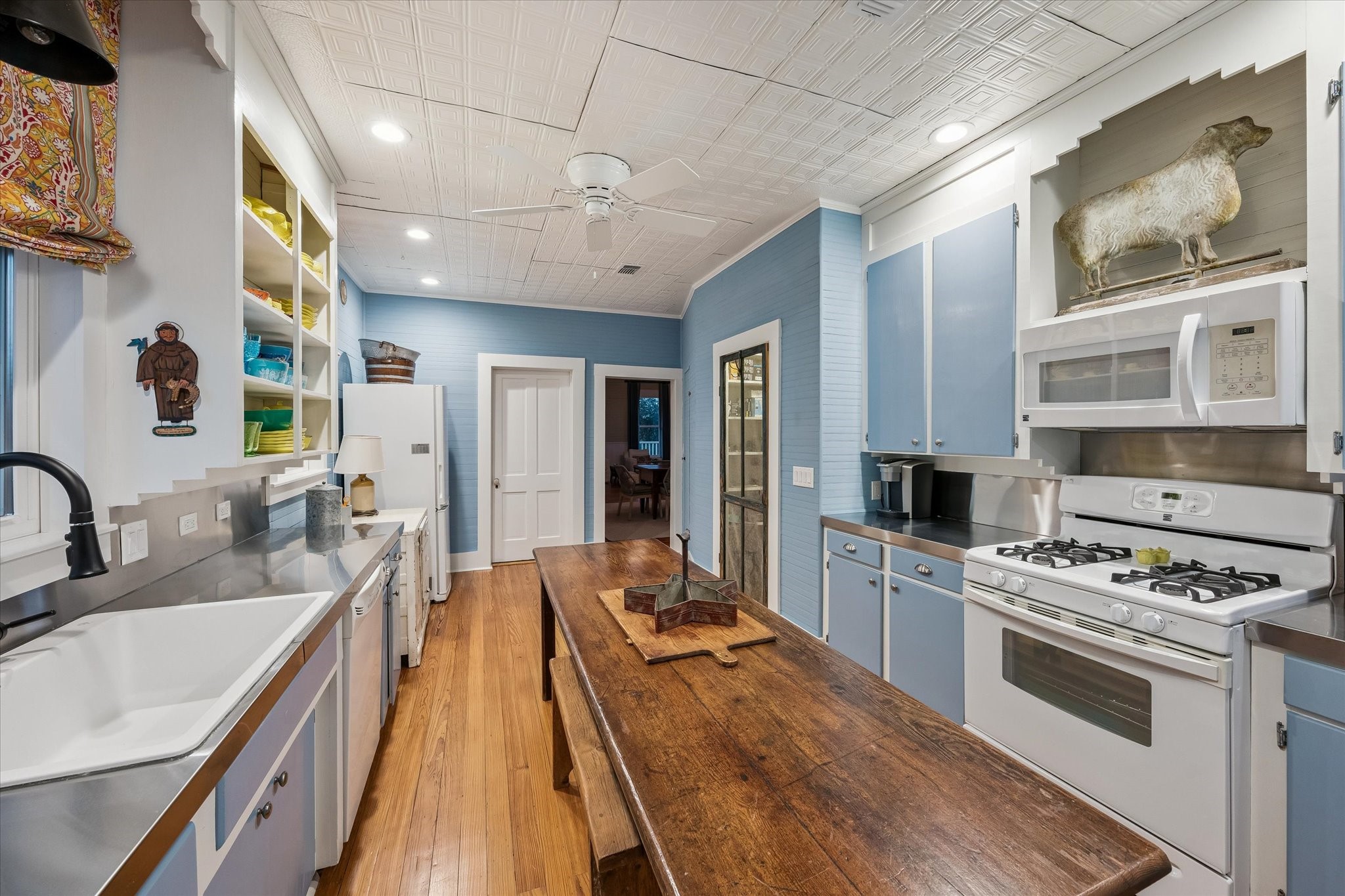 895 South Weyand Road Round Top, TX 78954 - Photo 5 of 37 a large kitchen with stainless steel appliances a stove a sink dishwasher and cabinets with wooden floor
