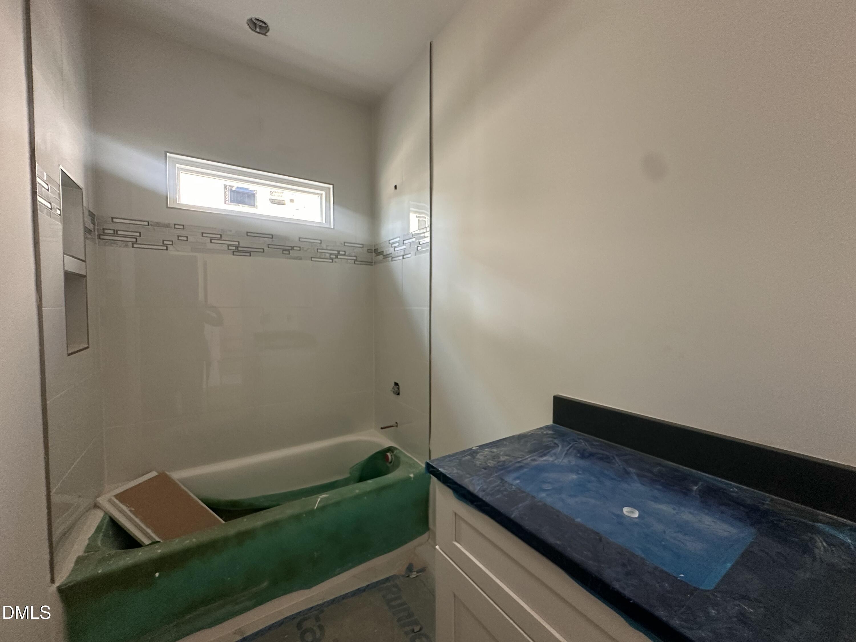 1521 Sunrise Avenue Raleigh, NC 27608 - Photo 5 of 19 a bathroom with a tub and vanity