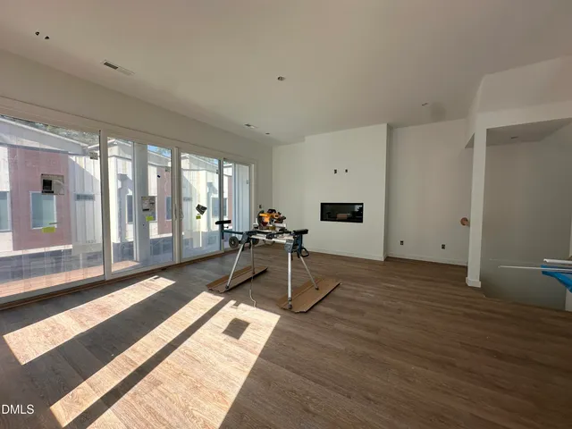 a view of a room with wooden floor and furniture