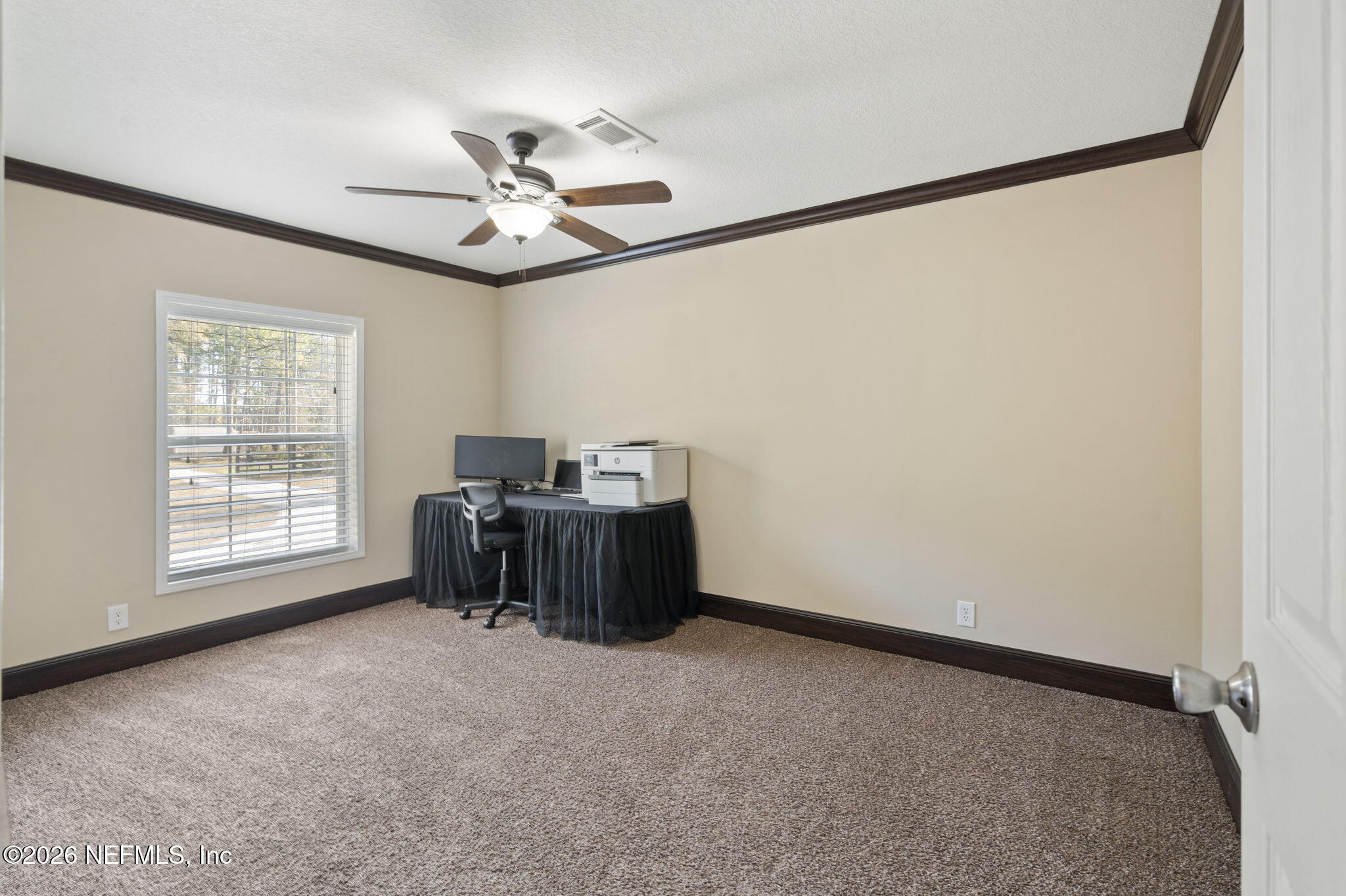 540605 Lem Turner Road Callahan, FL 32011 - Photo 11 of 31 an empty room with windows and fan