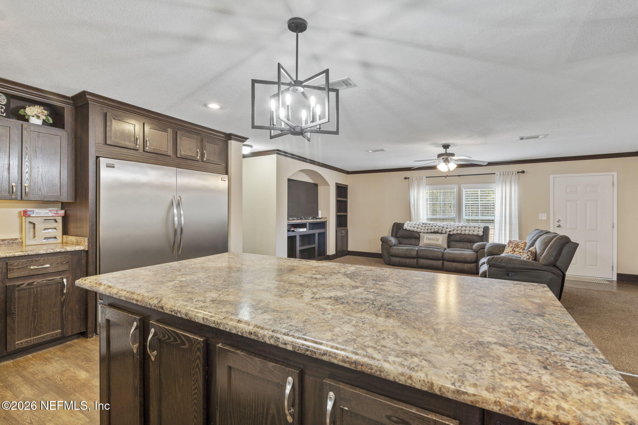 540605 Lem Turner Road Callahan, FL 32011 - Photo 17 of 31 a kitchen with stainless steel appliances granite countertop a sink refrigerator stove and microwave