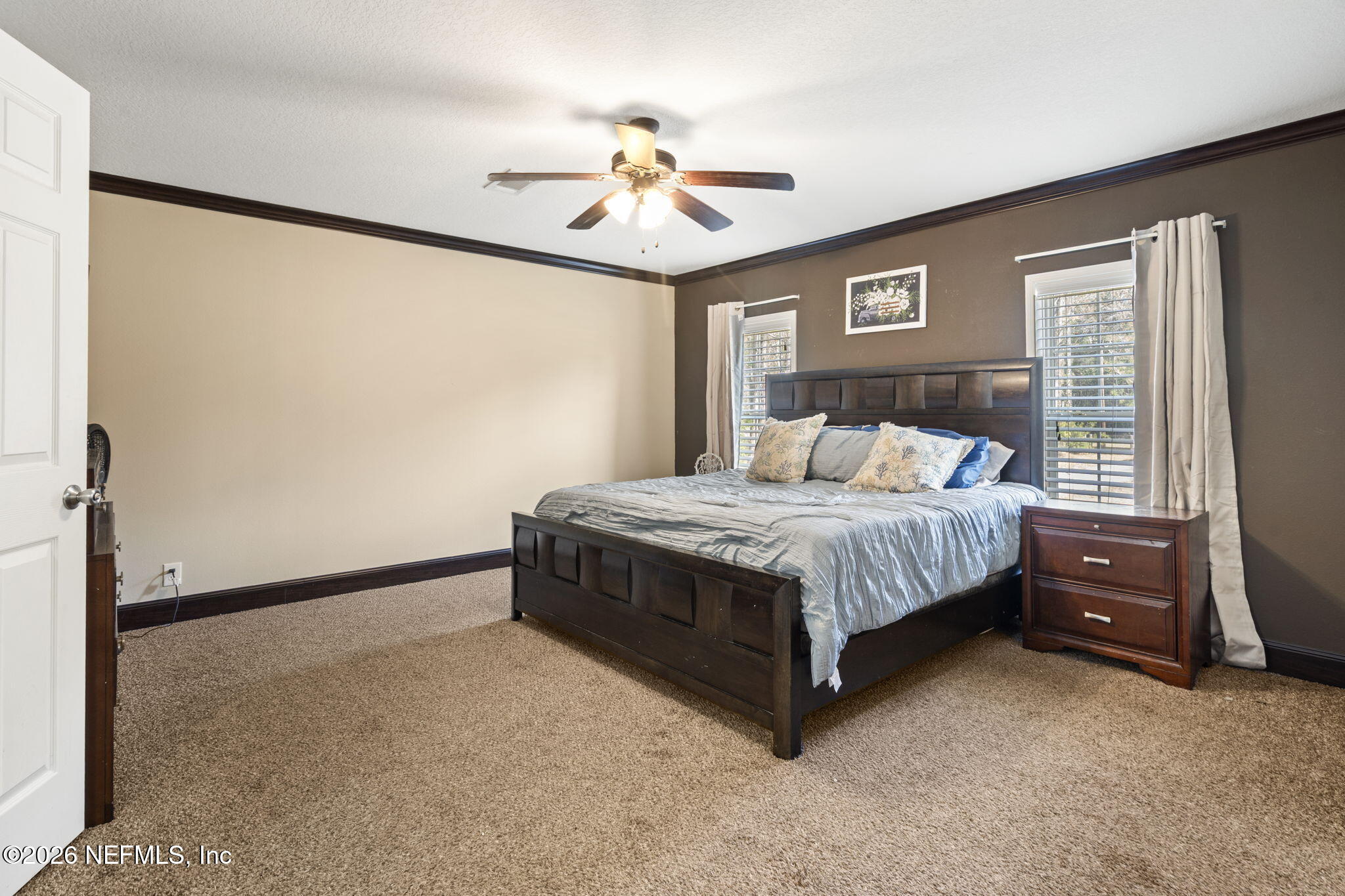 540605 Lem Turner Road Callahan, FL 32011 - Photo 18 of 31 a bedroom with a bed and a chandelier