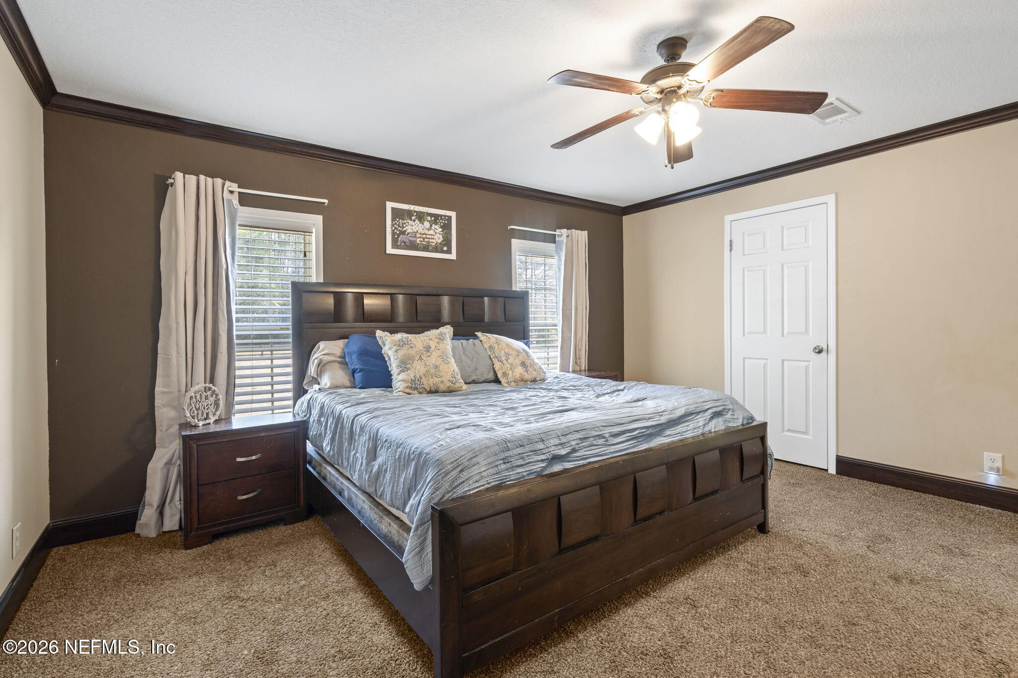 540605 Lem Turner Road Callahan, FL 32011 - Photo 19 of 31 a spacious bedroom with a bed and a chandelier