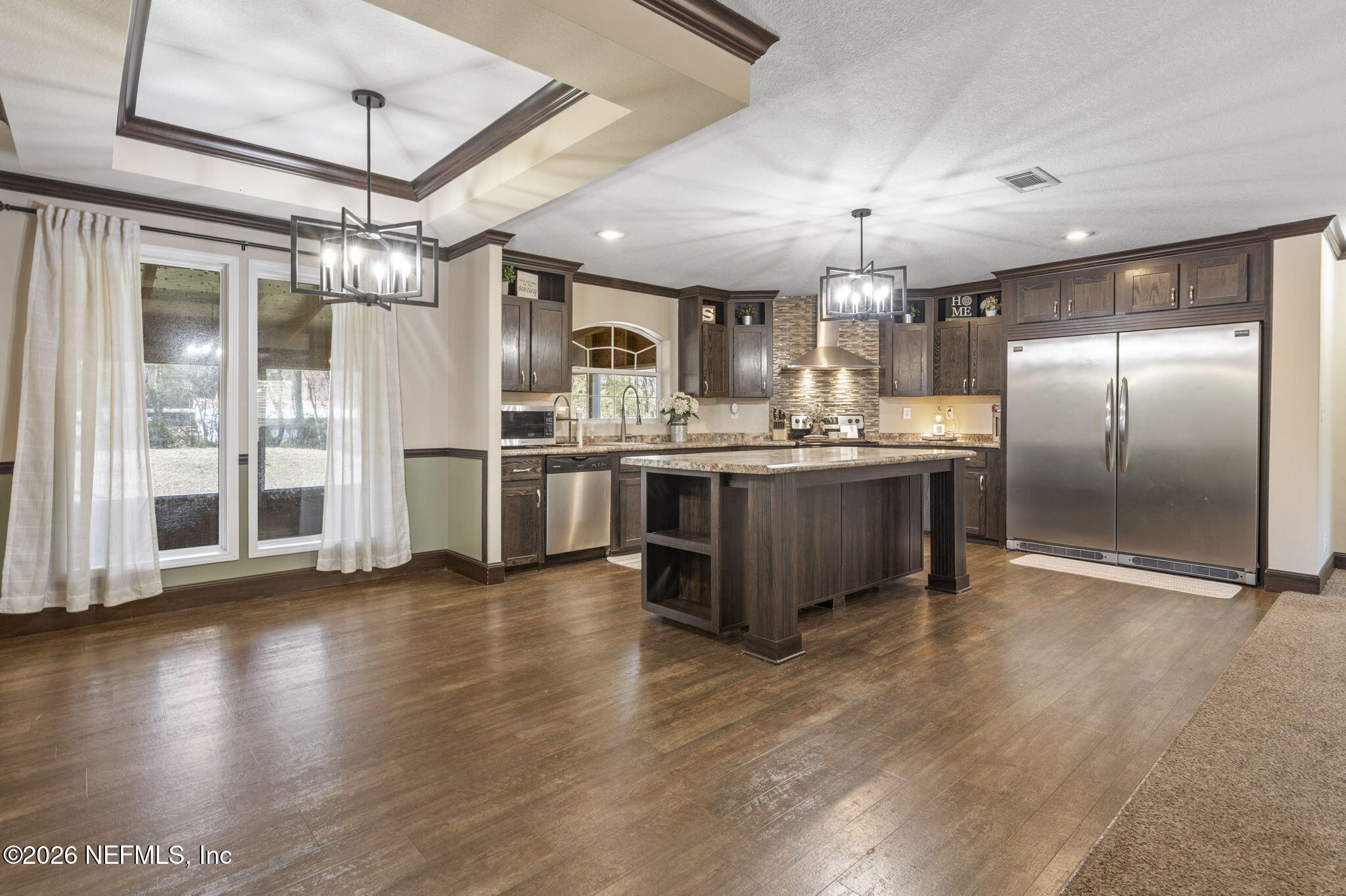 540605 Lem Turner Road Callahan, FL 32011 - Photo 2 of 31 a kitchen with stainless steel appliances granite countertop a refrigerator a stove and a wooden floors
