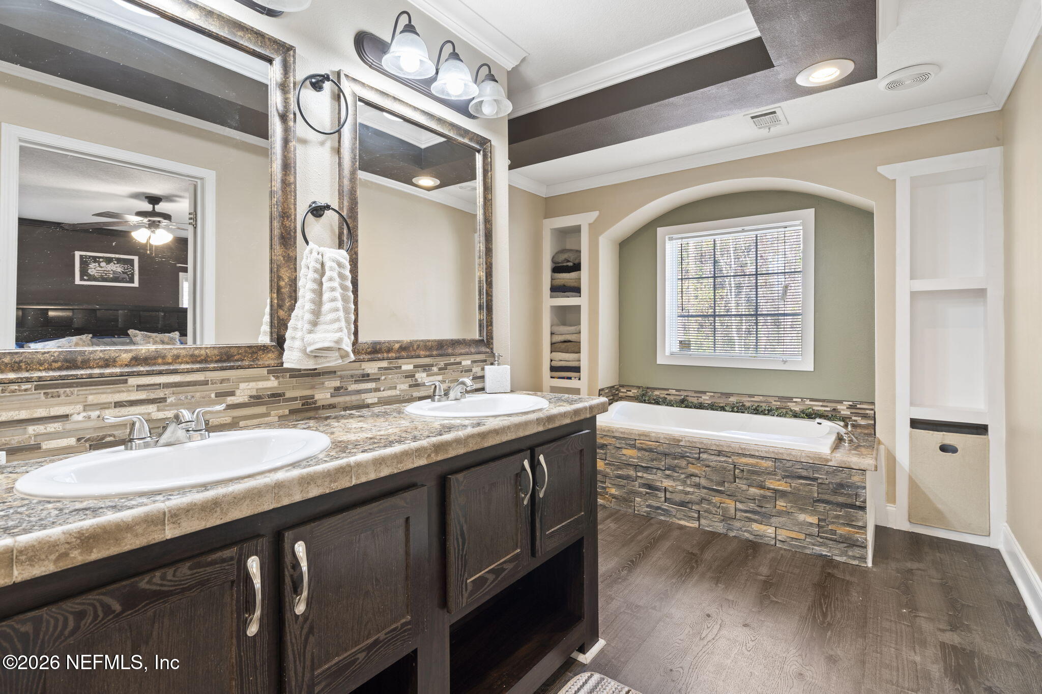 540605 Lem Turner Road Callahan, FL 32011 - Photo 22 of 31 a bathroom with a granite countertop sink a large mirror and a bathtub