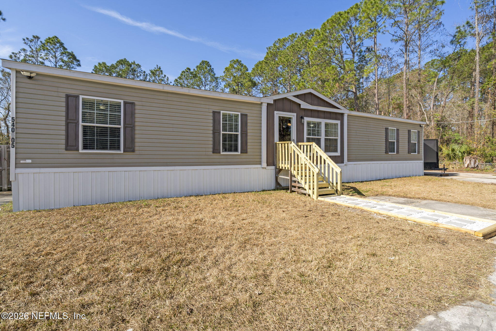 540605 Lem Turner Road Callahan, FL 32011 - Photo 28 of 31 a view of a house with backyard and a tree