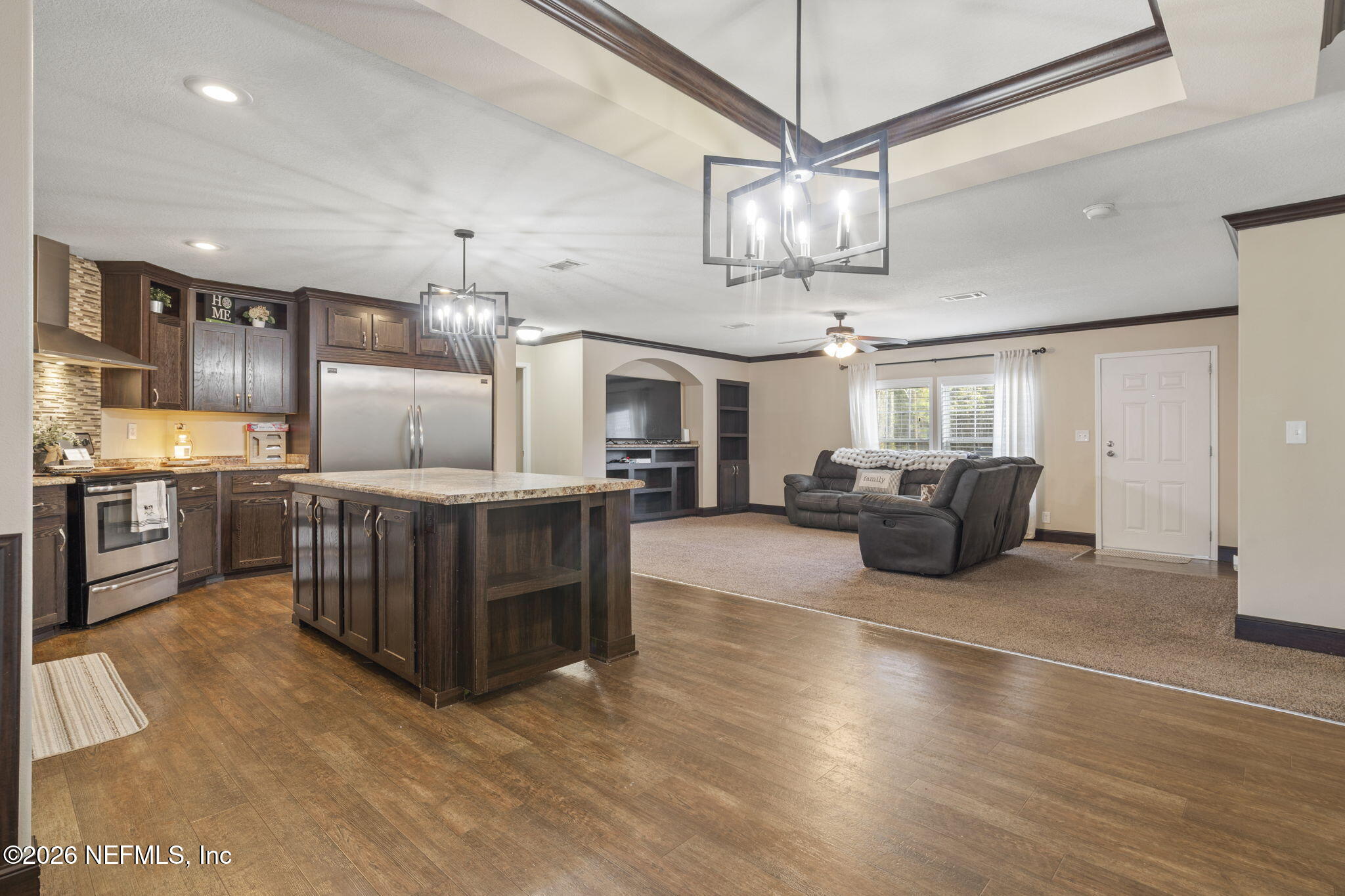 540605 Lem Turner Road Callahan, FL 32011 - Photo 3 of 31 a large room with lots of furniture and a chandelier