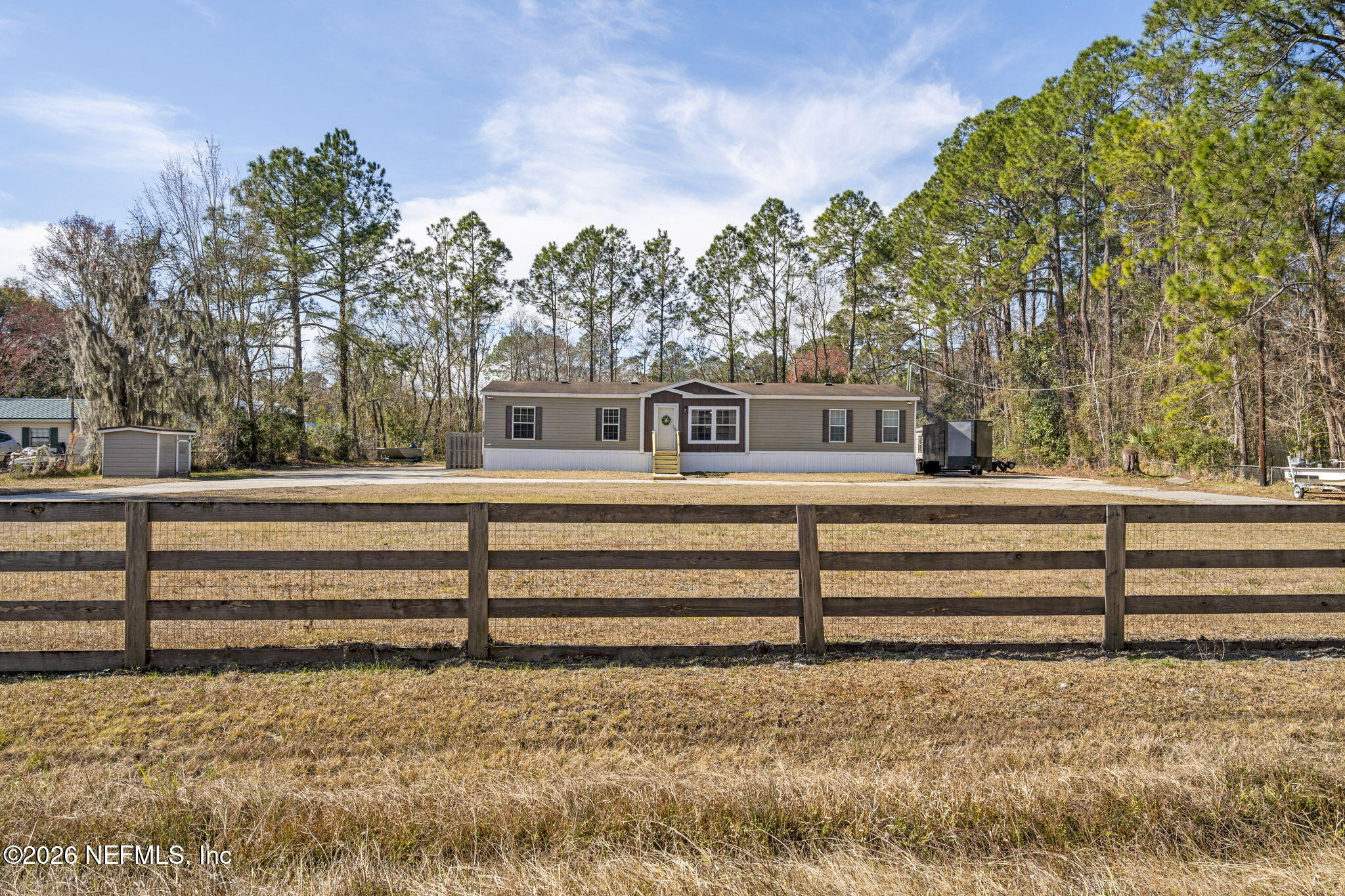 540605 Lem Turner Road Callahan, FL 32011 - Photo 31 of 31 a view of backyard with wooden fence and large trees