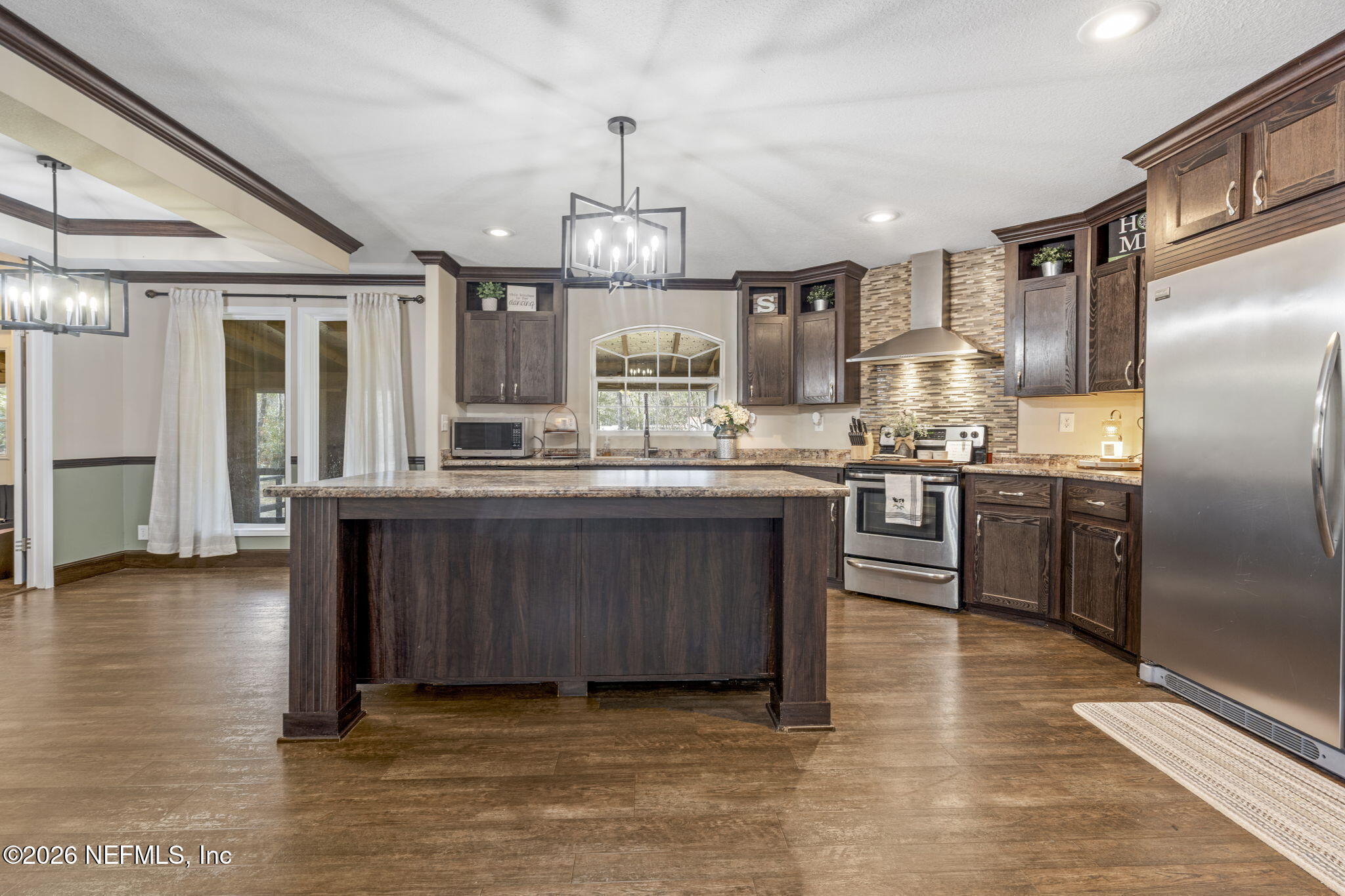 540605 Lem Turner Road Callahan, FL 32011 - Photo 4 of 31 a kitchen with stainless steel appliances granite countertop a sink a stove and a refrigerator