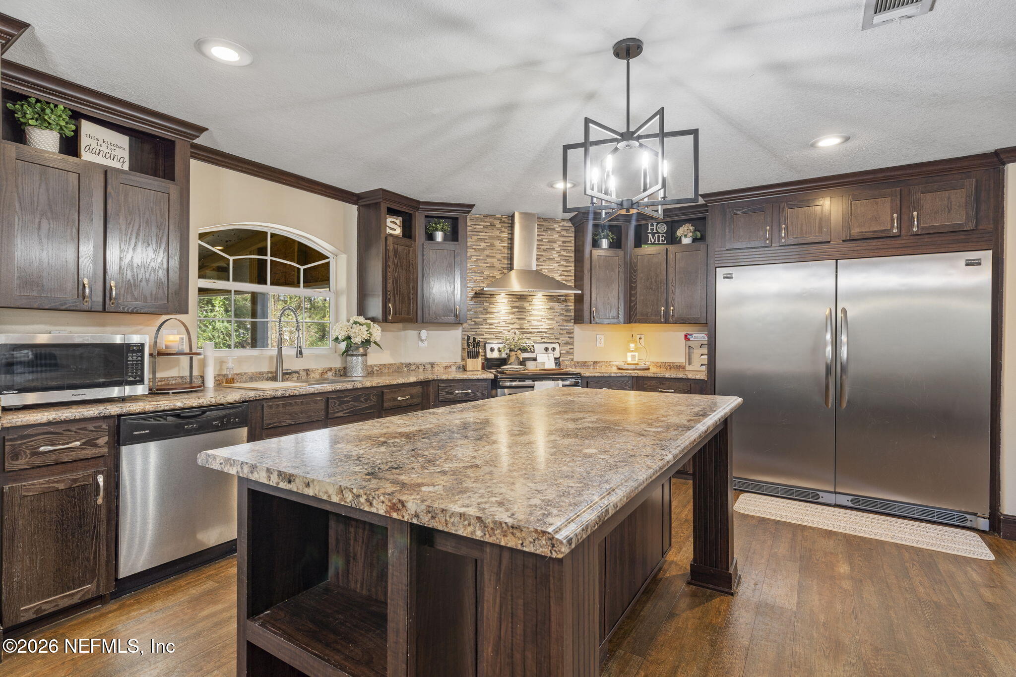 540605 Lem Turner Road Callahan, FL 32011 - Photo 5 of 31 a kitchen with stainless steel appliances granite countertop a sink dishwasher and a refrigerator
