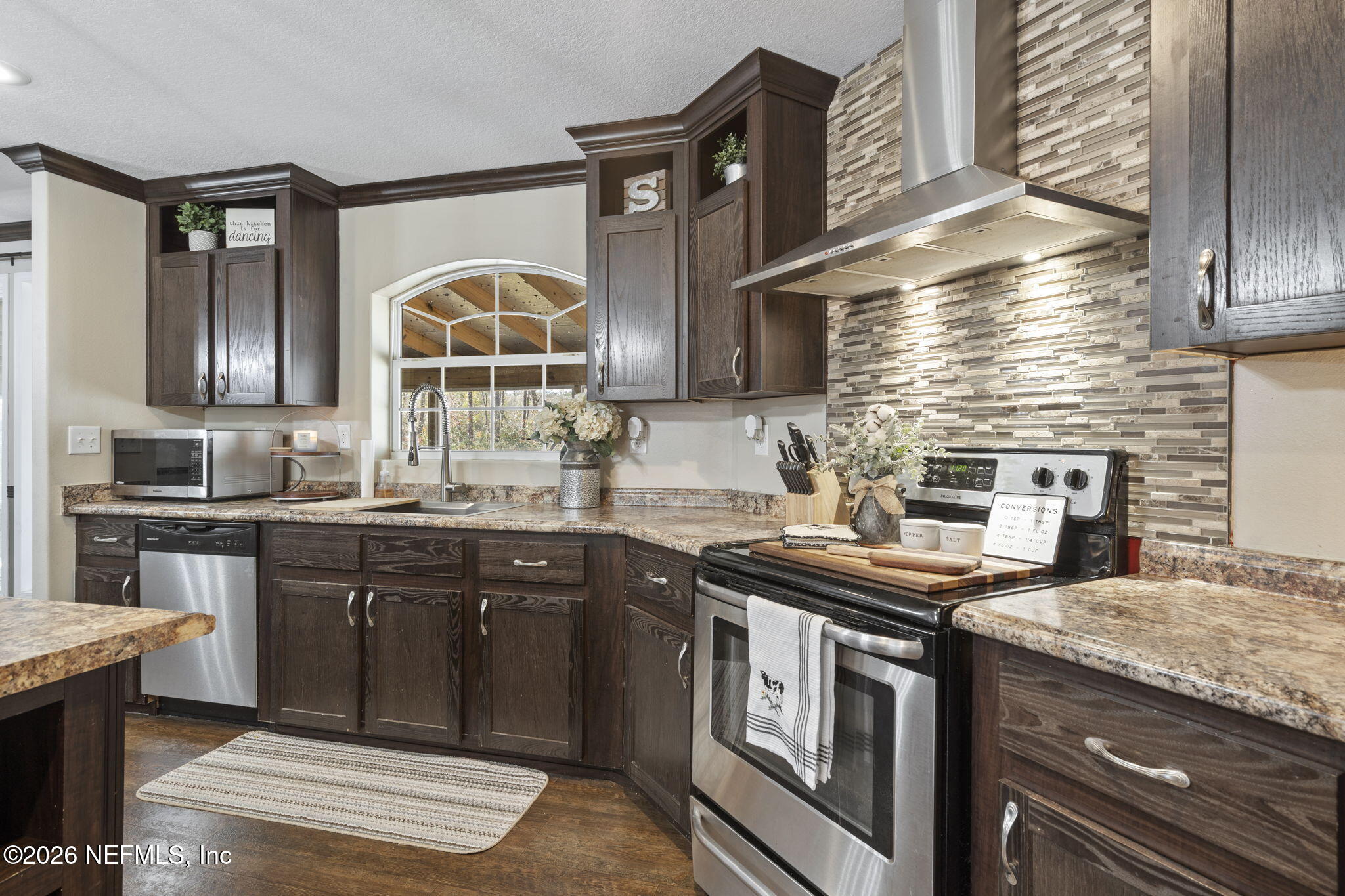 540605 Lem Turner Road Callahan, FL 32011 - Photo 6 of 31 a kitchen with stainless steel appliances granite countertop a stove a sink and a microwave
