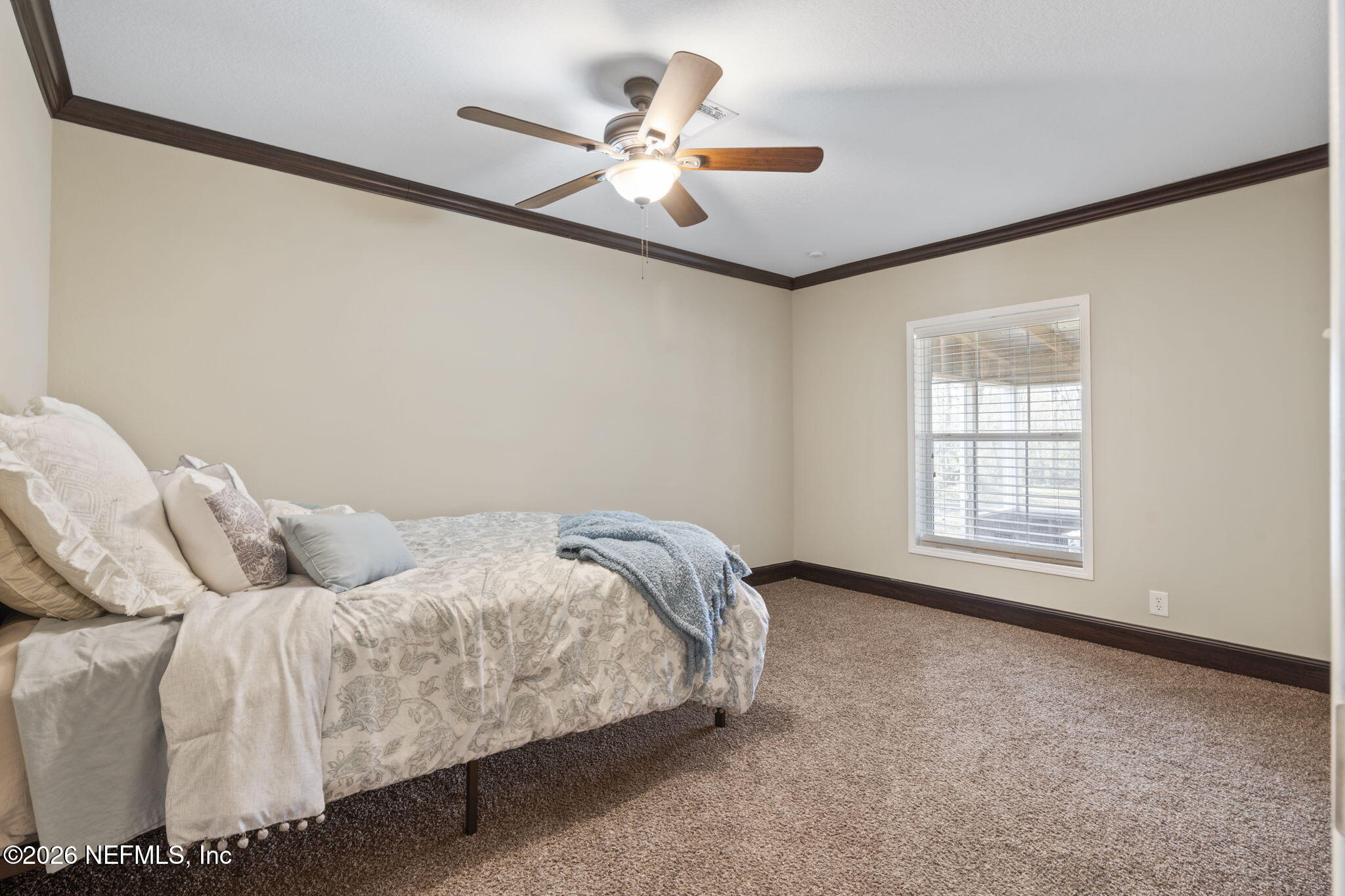 540605 Lem Turner Road Callahan, FL 32011 - Photo 7 of 31 a bedroom with a bed and a ceiling fan