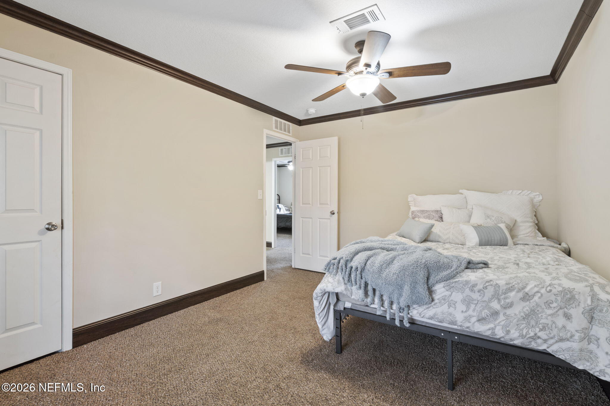 540605 Lem Turner Road Callahan, FL 32011 - Photo 8 of 31 a bedroom with a bed and a chandelier