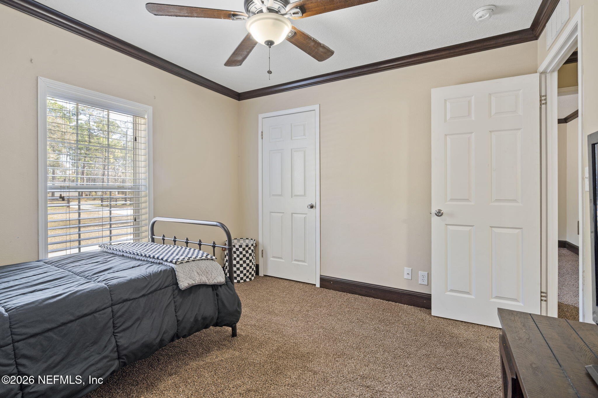 540605 Lem Turner Road Callahan, FL 32011 - Photo 10 of 31 a spacious bedroom with a bed and a chandelier