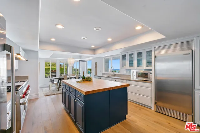 a kitchen with stainless steel appliances granite countertop a sink and stove