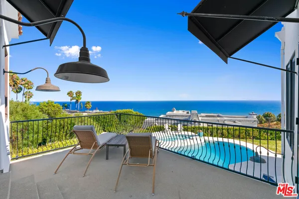 a view of a balcony with dining area