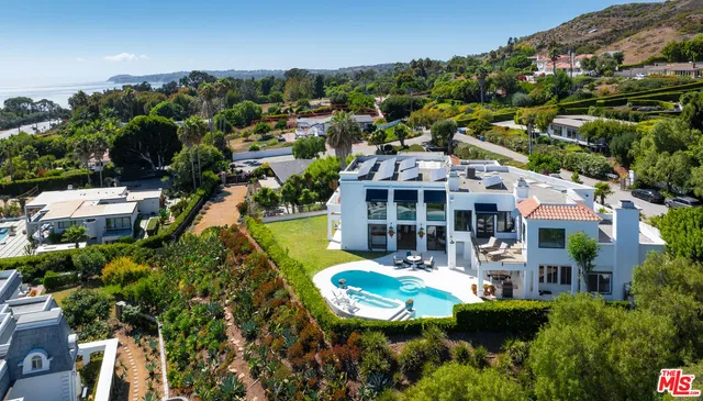 an aerial view of a house with swimming pool outdoor seating and yard