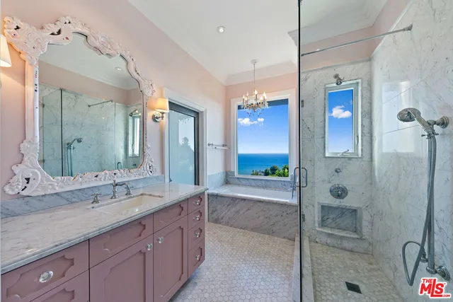 a spacious bedroom with a bed couch and a large window with outer view