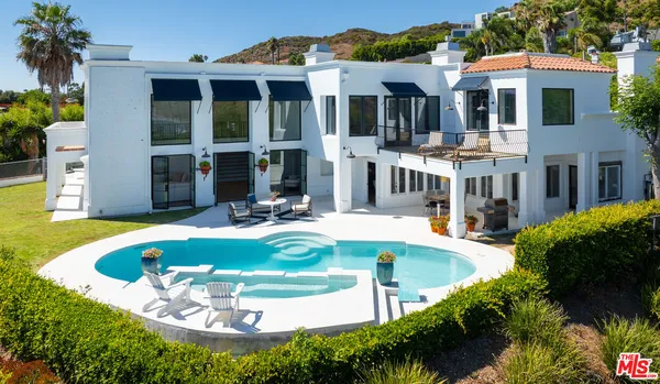 a view of a house with swimming pool and porch