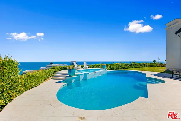 a view of a house with swimming pool and porch