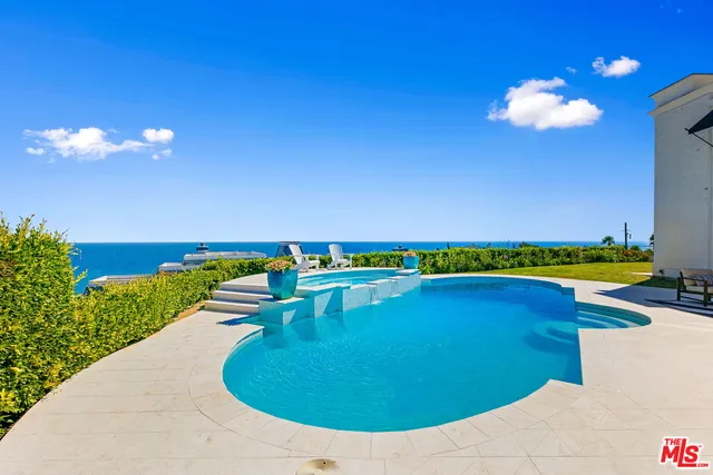 a view of a house with swimming pool and porch