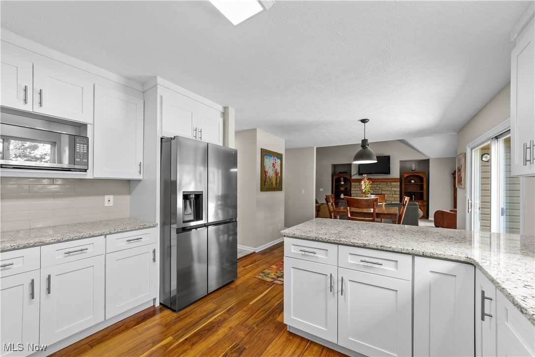 30825 Cannon Road Solon, OH 44139 - Photo 16 of 49 Kitchen featuring white cabinetry and decorative backsplash