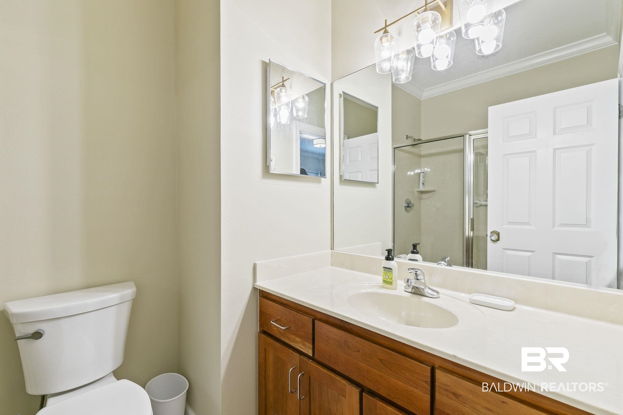 17341 Cabin Road Loxley, AL 36551 - Photo 31 of 49 Bathroom featuring vanity, toilet, an enclosed shower, and crown molding
