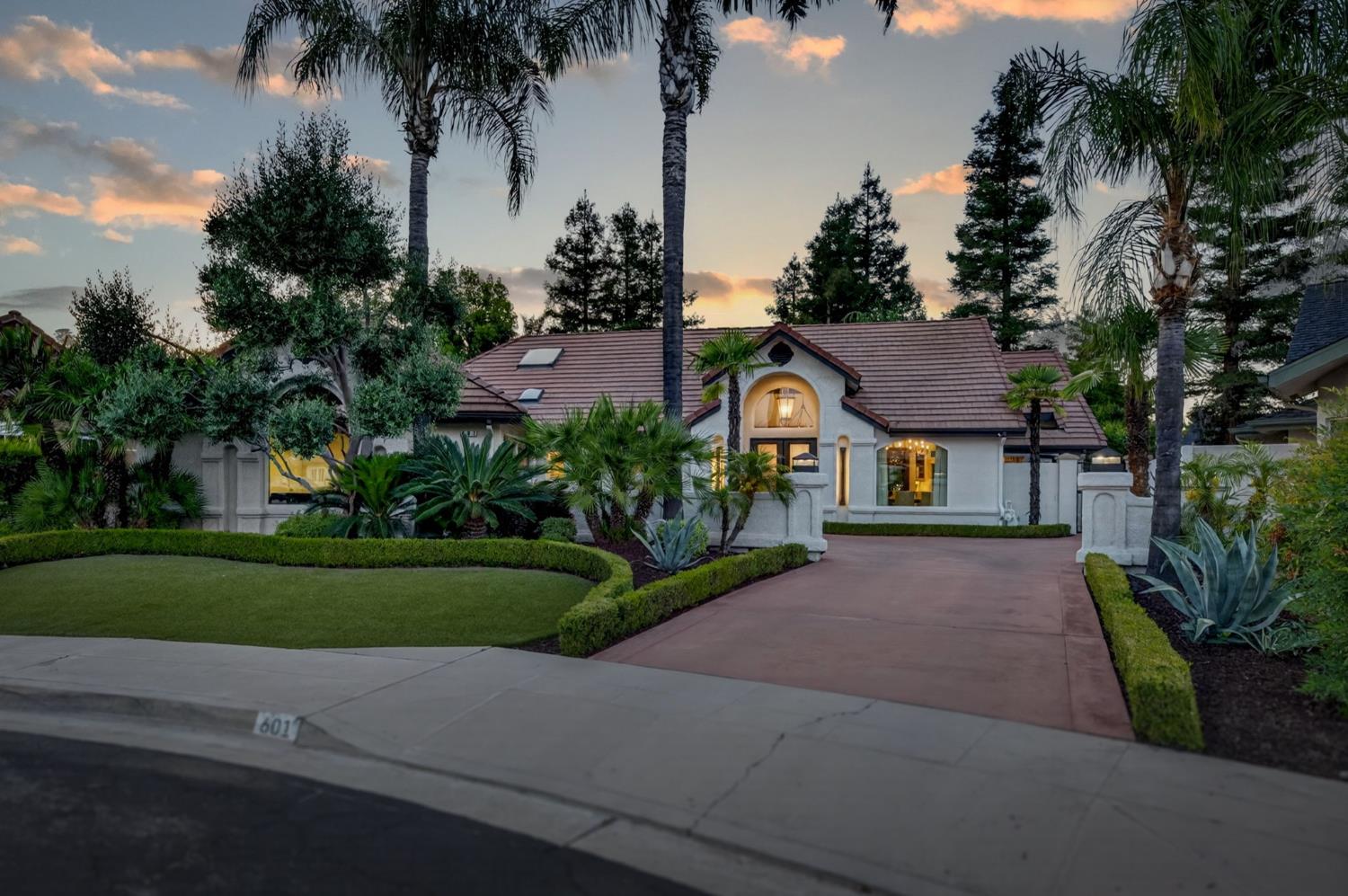 601 Decatur Avenue Clovis, CA 93611 - Photo 3 of 62 a front view of a house with a garden and trees