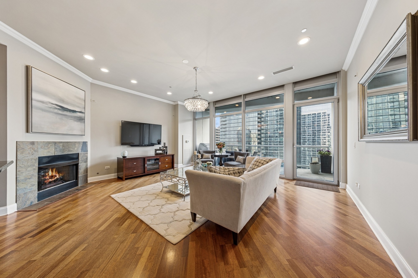 333 North Canal Street, Unit 2505 Chicago, IL 60606 - Photo 3 of 17 a living room with fireplace furniture and a flat screen tv