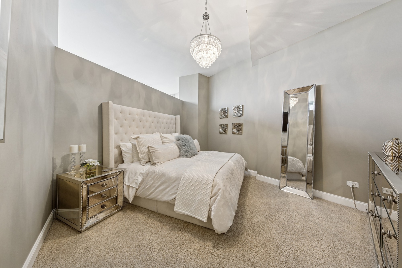 333 North Canal Street, Unit 2505 Chicago, IL 60606 - Photo 9 of 17 a spacious bedroom with a bed and a chandelier