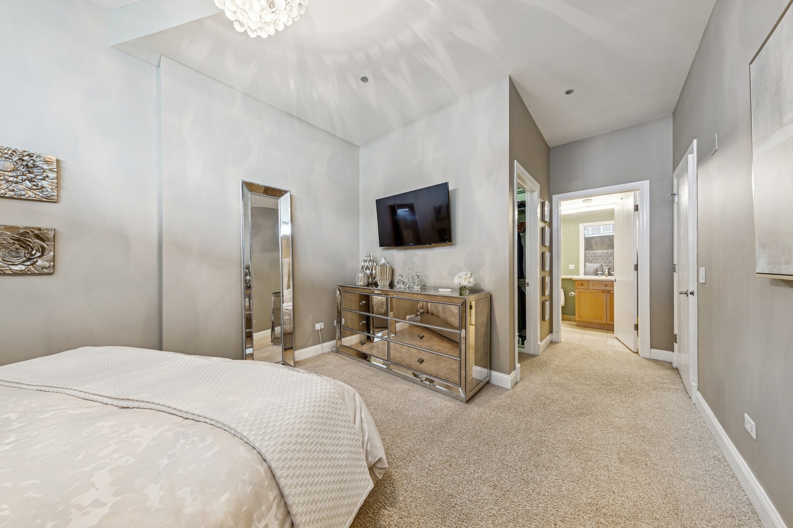 333 North Canal Street, Unit 2505 Chicago, IL 60606 - Photo 10 of 17 a bedroom with a bed and a flat tv screen on wall