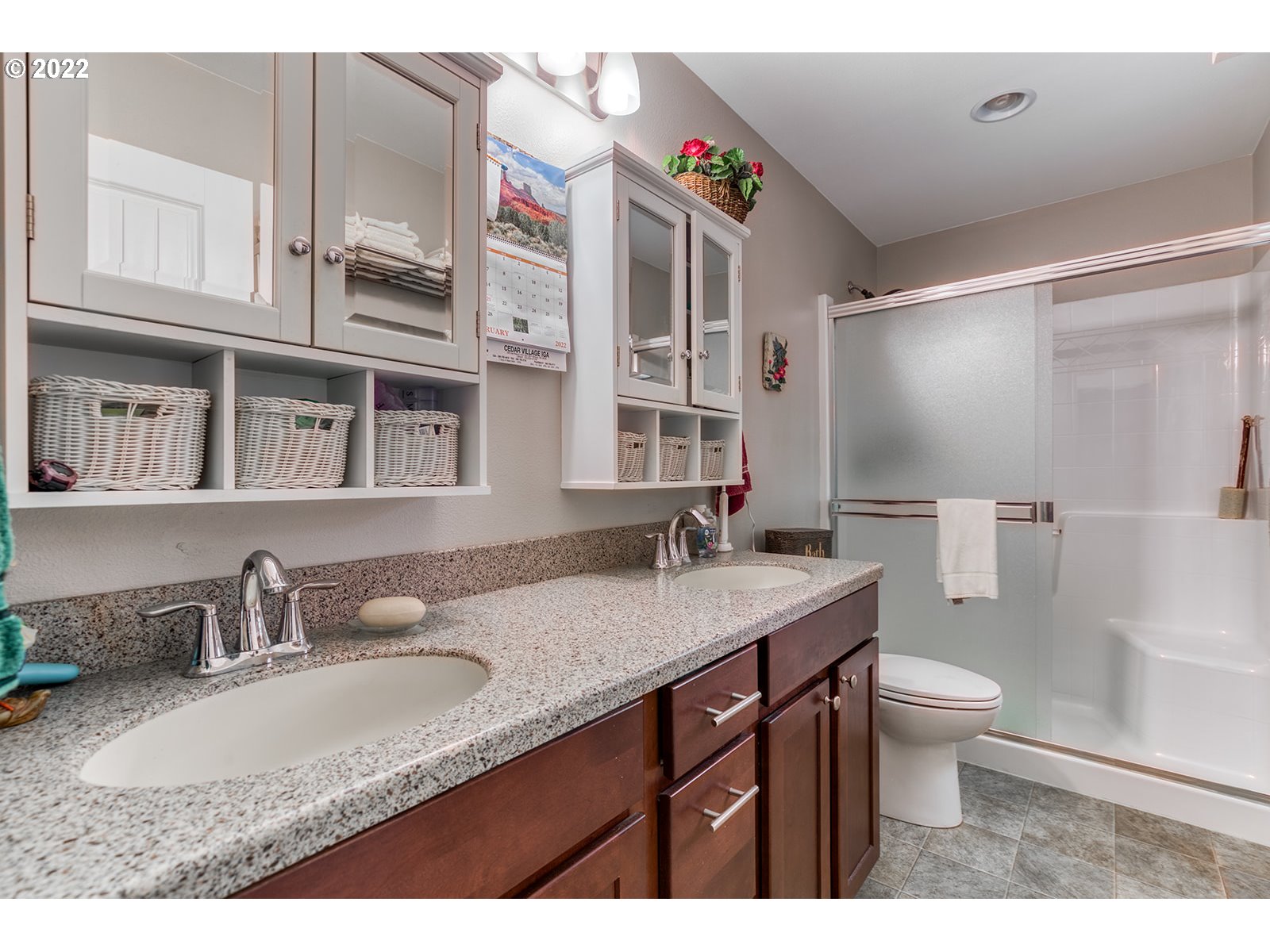 448 Hawkins Road Winlock, WA 98596 - Photo 17 of 32 a bathroom with a granite countertop sink a toilet a mirror and shower