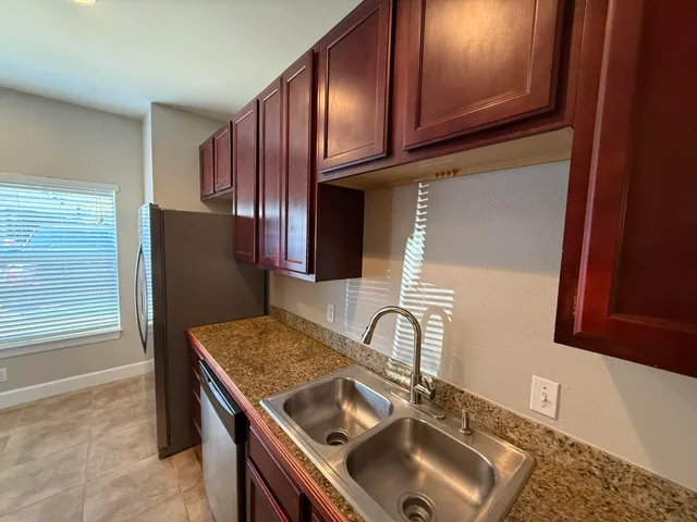 a kitchen with a sink stove and microwave