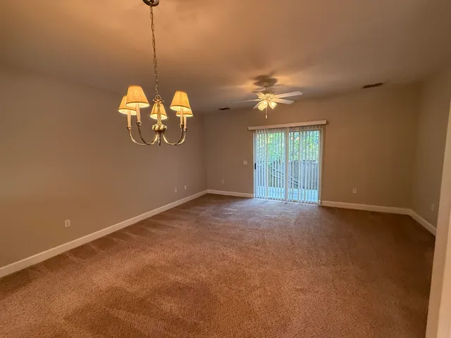 a view of a chandelier fan and a window in a room