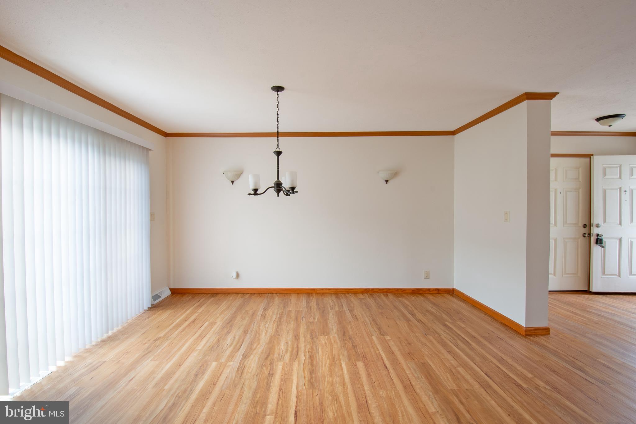 116 Lavender Lane, Unit 4 Magnolia, DE 19962 - Photo 12 of 26 a view of an empty room with wooden floor and a window