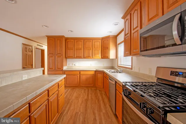 a kitchen with stainless steel appliances granite countertop a stove and a sink