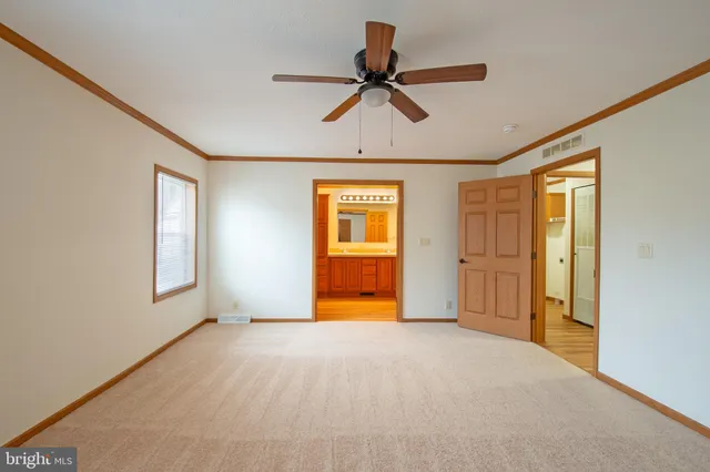 a view of empty room with ceiling fan