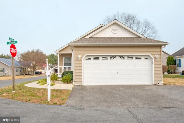 a view of the house with a yard and garage