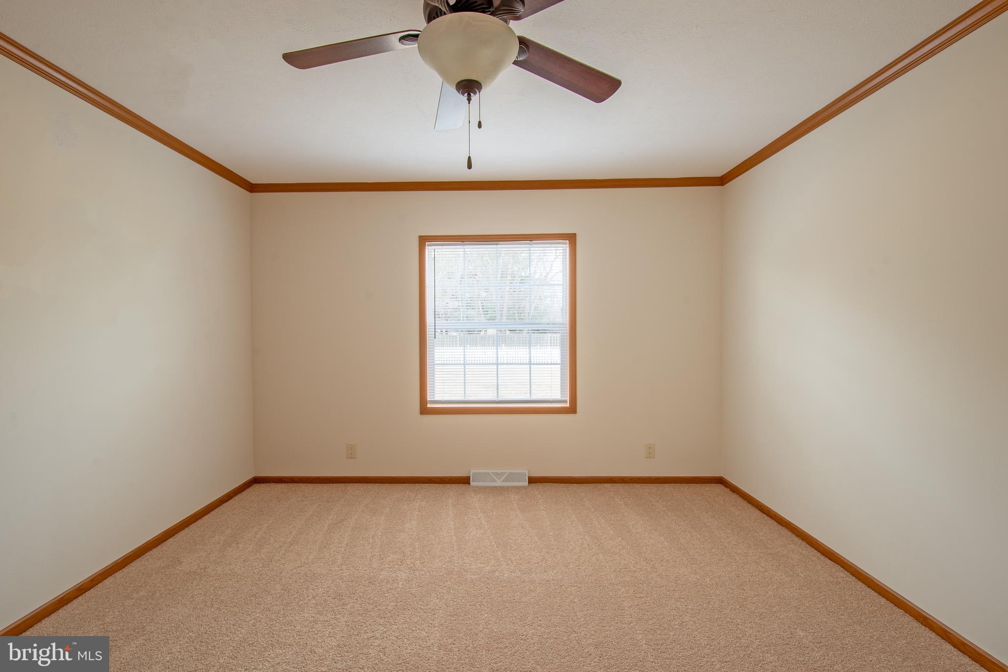 116 Lavender Lane, Unit 4 Magnolia, DE 19962 - Photo 25 of 26 an empty room with a window and a ceiling fan