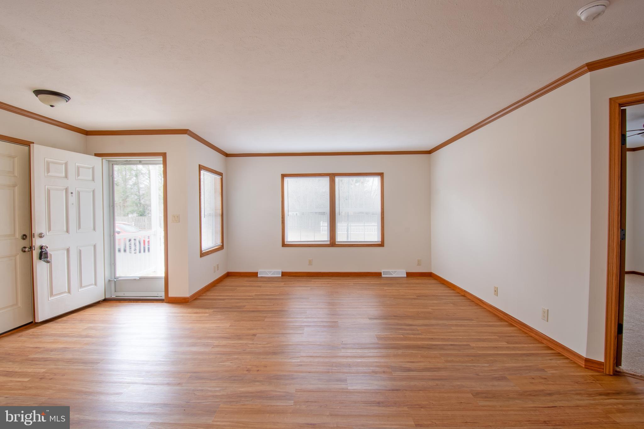 116 Lavender Lane, Unit 4 Magnolia, DE 19962 - Photo 7 of 26 a view of an empty room with wooden floor and a window