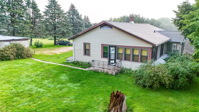 a front view of house with yard and green space