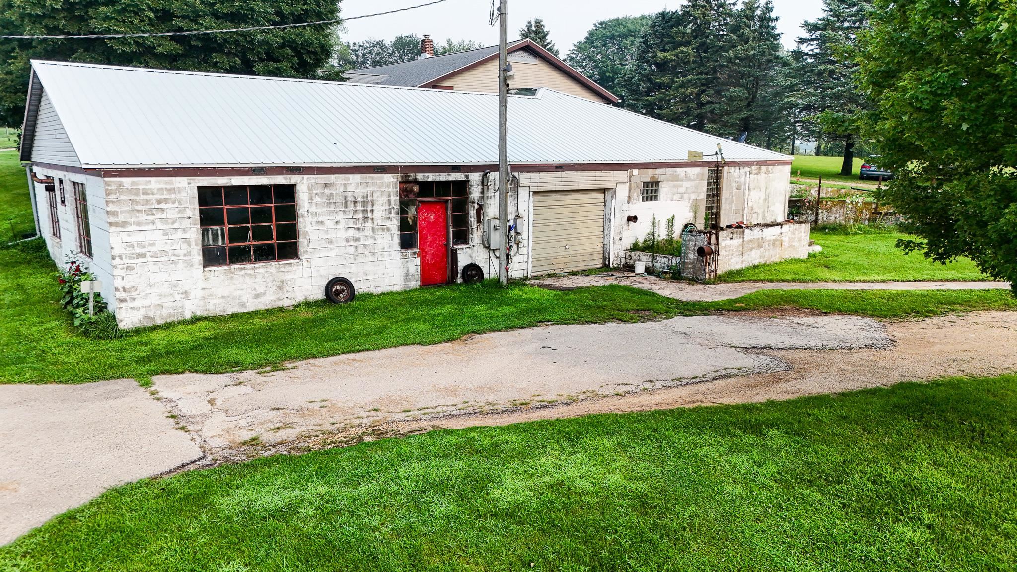7916 West Pines Road Polo, IL 61064 - Photo 23 of 42 a view of a white house next to a yard and large trees