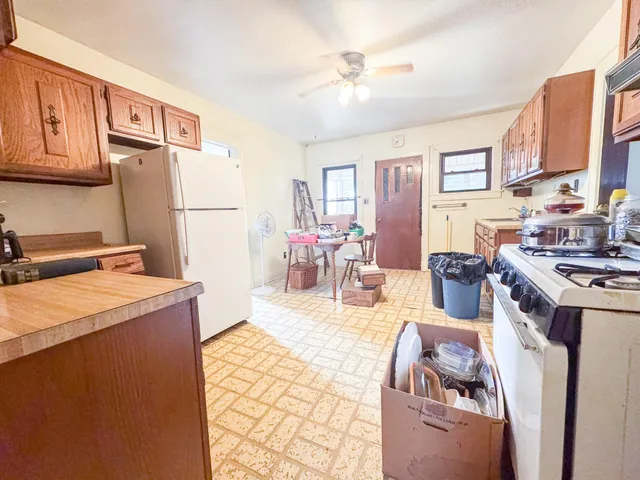 a kitchen with a stove a refrigerator and a dining table