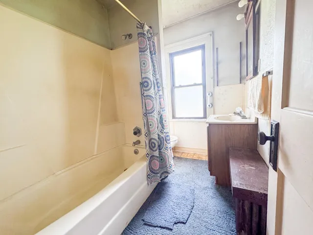 a bathroom with a bathtub and a shower