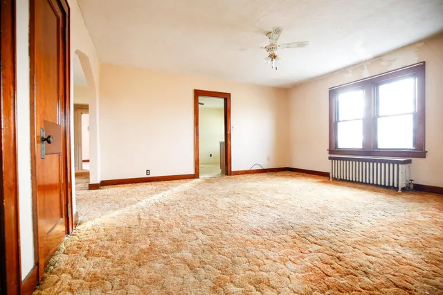 an empty room with windows and closet