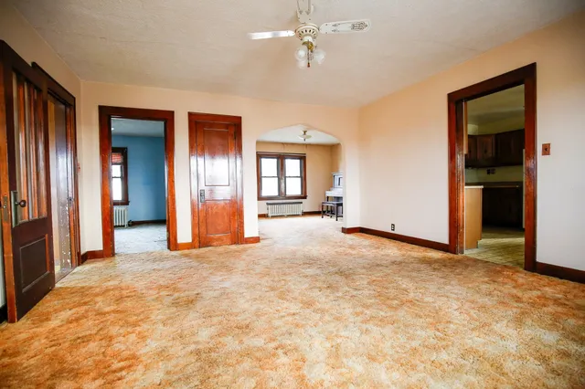 an empty room with windows and closet