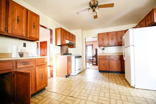 a kitchen with stainless steel appliances granite countertop a refrigerator a stove a sink dishwasher and wooden cabinets