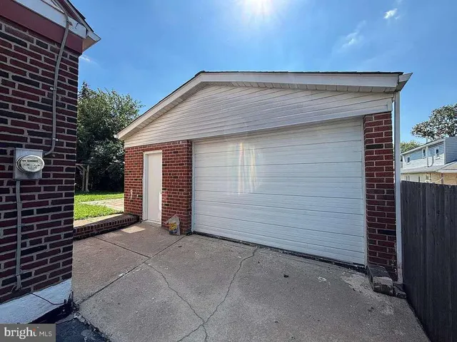 a view of house with backyard and glass windows