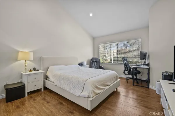 a bedroom with a bed and a large window